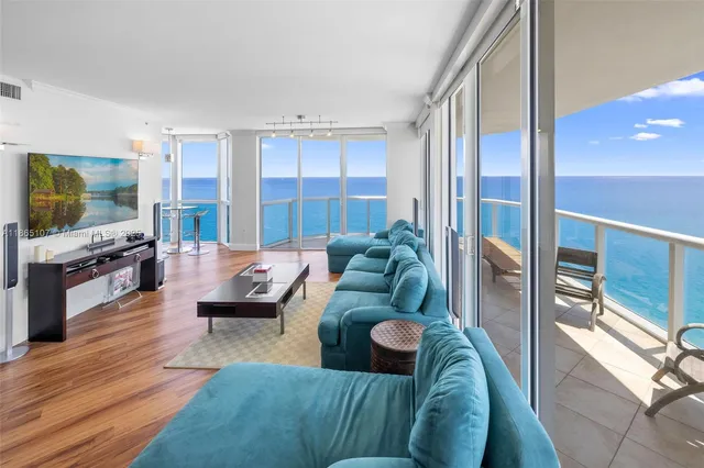 a kitchen with granite countertop a sink a counter top space cabinets stainless steel appliances and a window