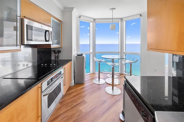 a kitchen with kitchen island a counter and a refrigerator
