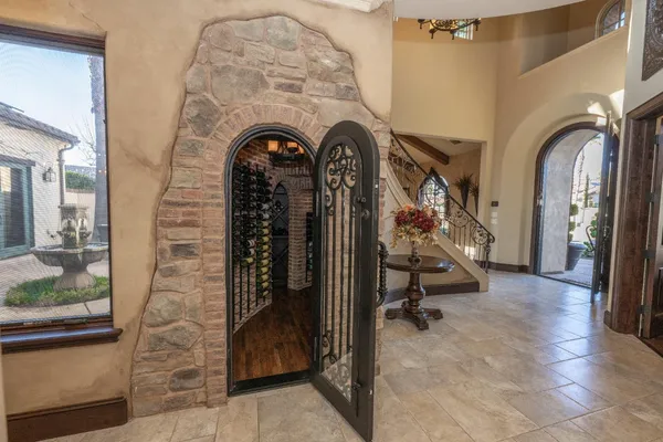 a living room with furniture a fireplace and a large window