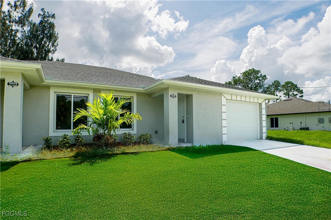 2020 East 12th Street Lehigh Acres, FL 33972 - Photo 1 of 17 a front view of house with yard and green space
