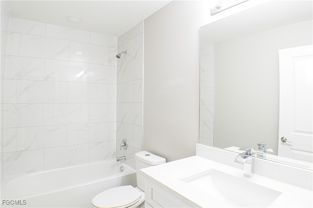 2020 East 12th Street Lehigh Acres, FL 33972 - Photo 11 of 17 a bathroom with a sink toilet and shower