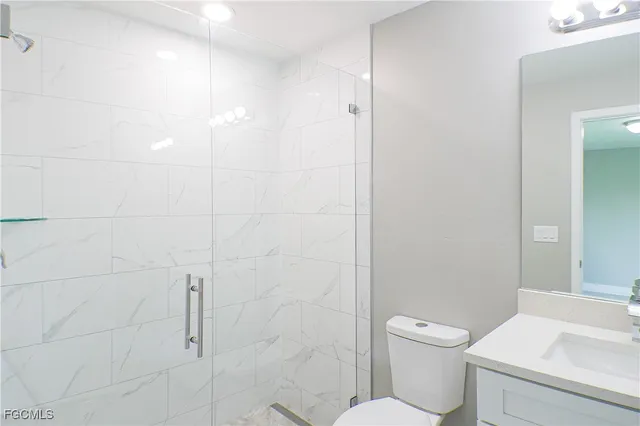 a white toilet sitting next to a bathroom sink