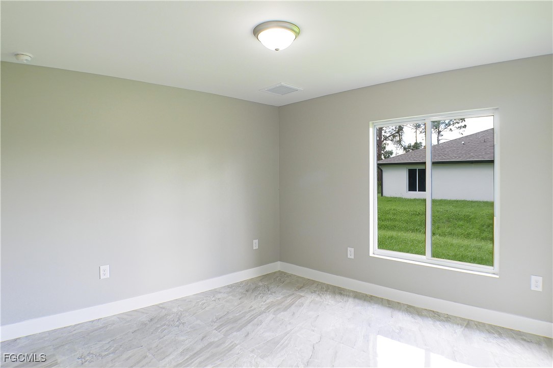 2020 East 12th Street Lehigh Acres, FL 33972 - Photo 7 of 17 an empty room with windows