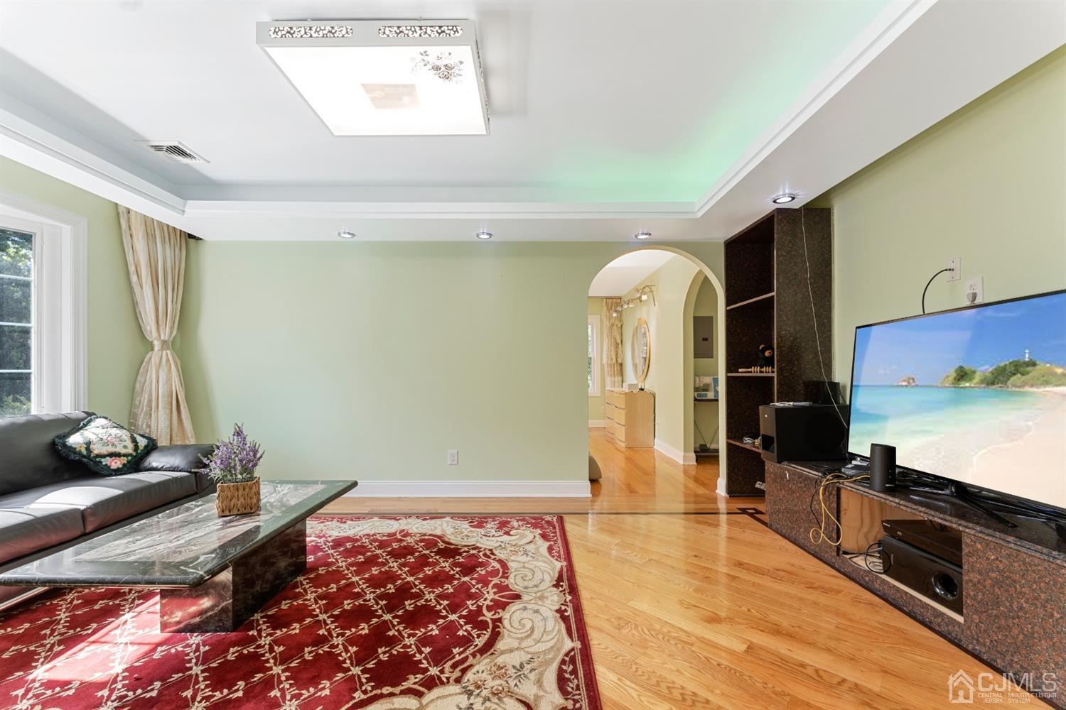 429 Plainfield Road Edison, NJ 08820 - Photo 15 of 26 a spacious bedroom with a bed and a flat screen tv
