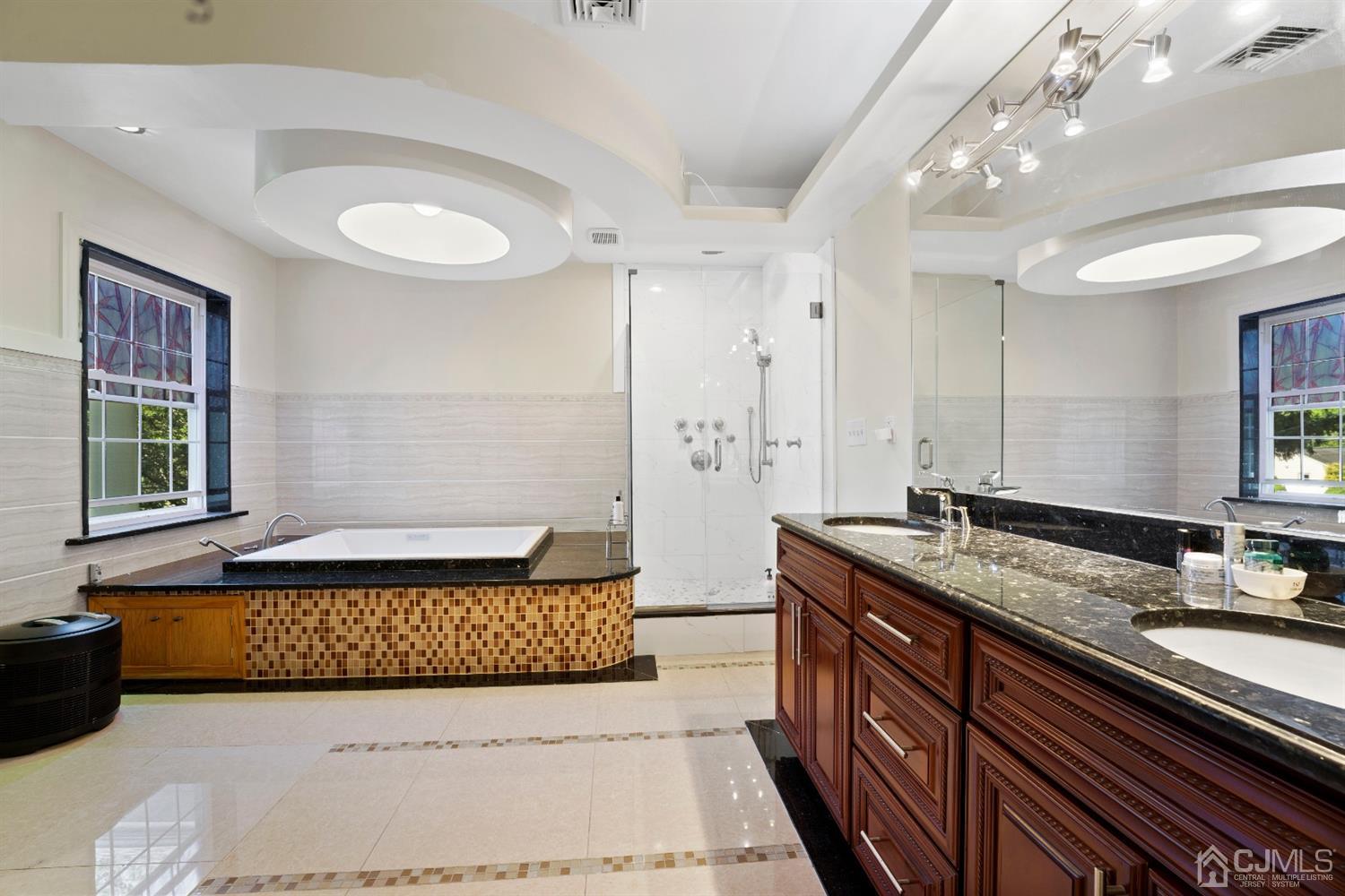 429 Plainfield Road Edison, NJ 08820 - Photo 17 of 26 a spacious bathroom with a granite countertop double vanity sink a mirror and a bathtub