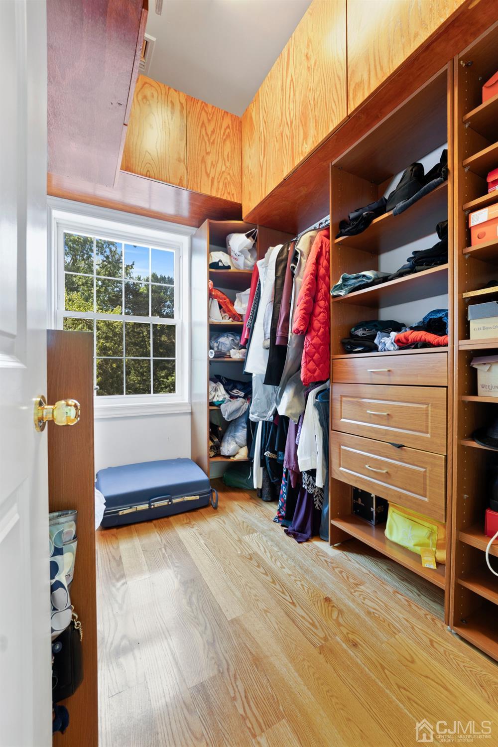 429 Plainfield Road Edison, NJ 08820 - Photo 19 of 26 a view of walk in closet with clothes and shoes