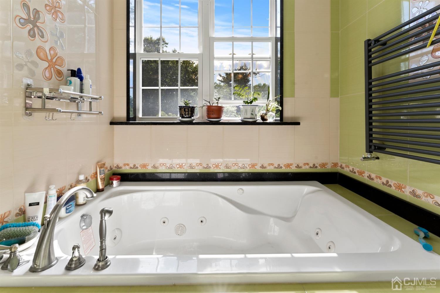 429 Plainfield Road Edison, NJ 08820 - Photo 24 of 26 a white bath tub sitting next to a window