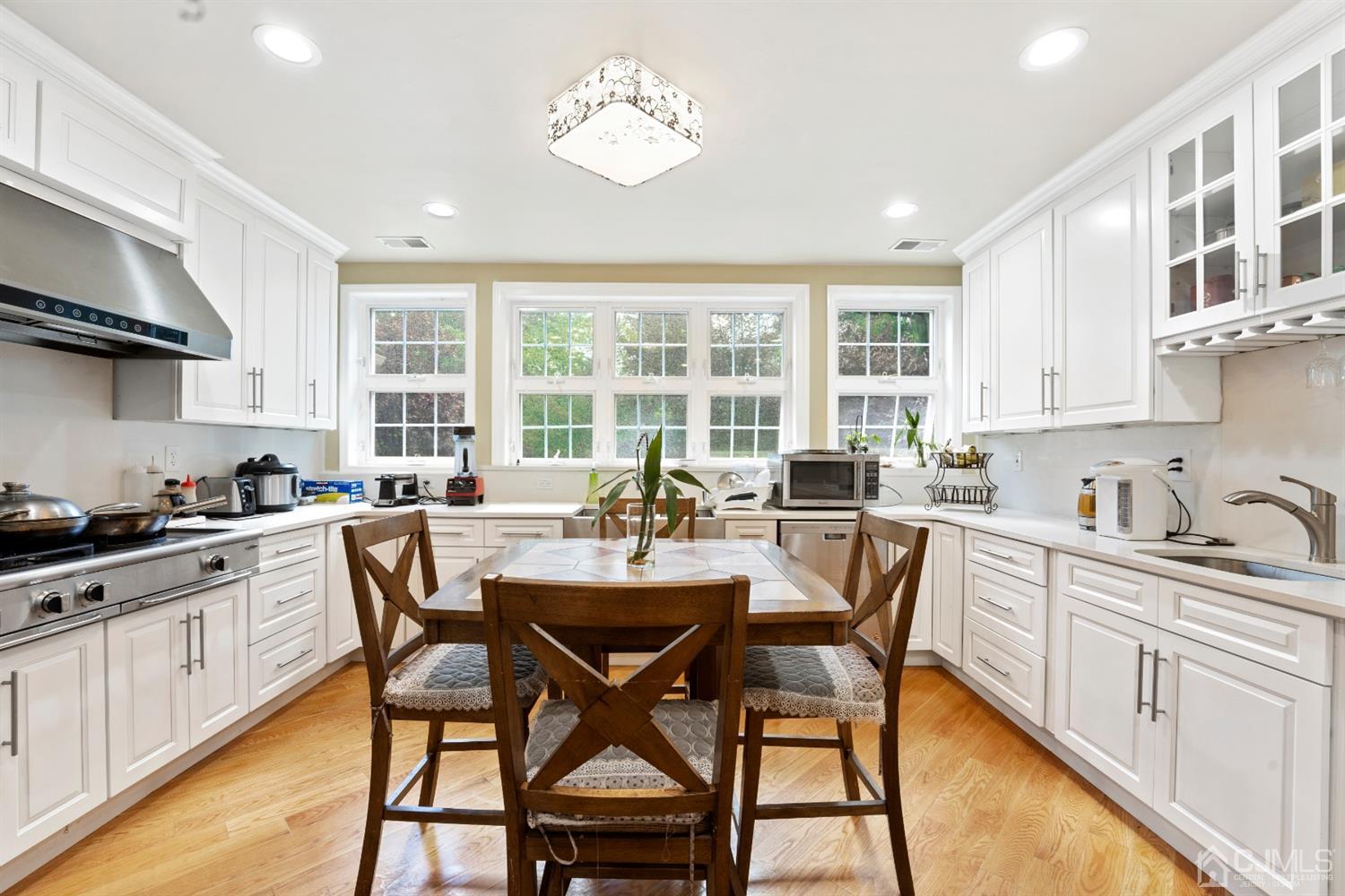 429 Plainfield Road Edison, NJ 08820 - Photo 7 of 26 a kitchen with stainless steel appliances kitchen island a table chairs and a sink
