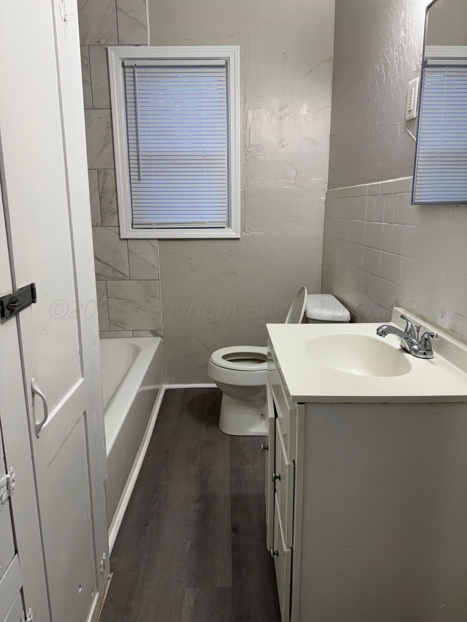 3807 South Polk Street Amarillo, TX 79110 - Photo 12 of 17 a bathroom with a sink a toilet and shower