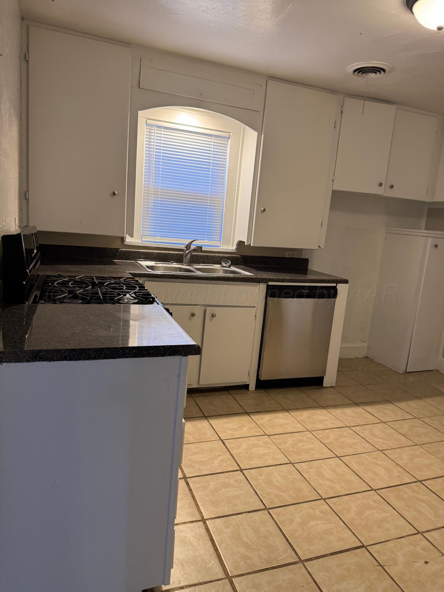 3807 South Polk Street Amarillo, TX 79110 - Photo 9 of 17 a kitchen with a sink and a stove top oven