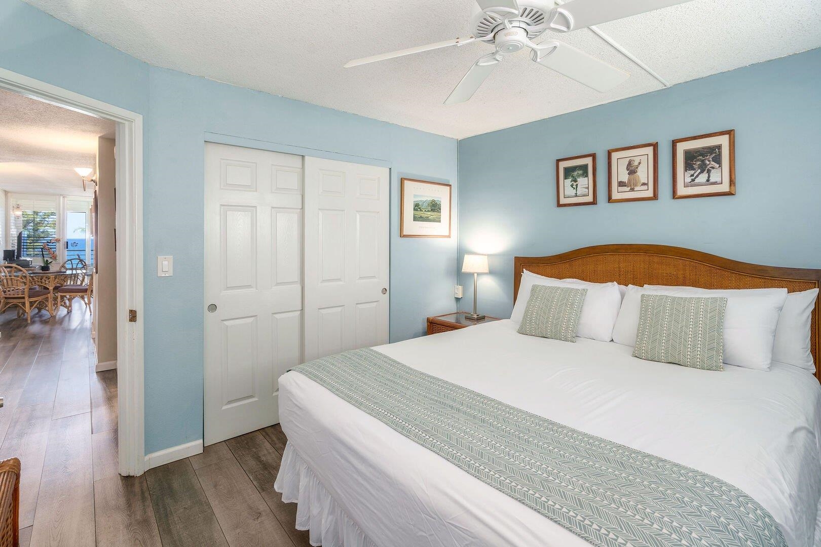 2385 South Kihei Road, Unit 409 Kihei, HI 96753 - Photo 16 of 34 a bedroom with a large bed and a chandelier