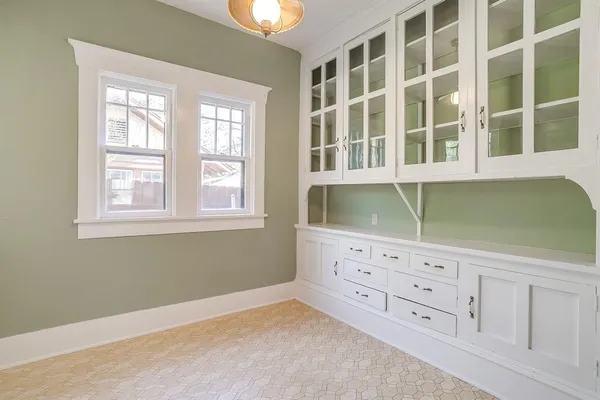a kitchen with a refrigerator a sink dishwasher with a dining table and chairs