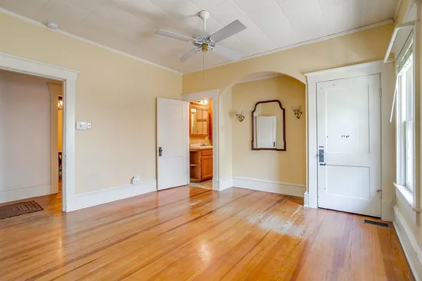 a view of an empty room with wooden floor