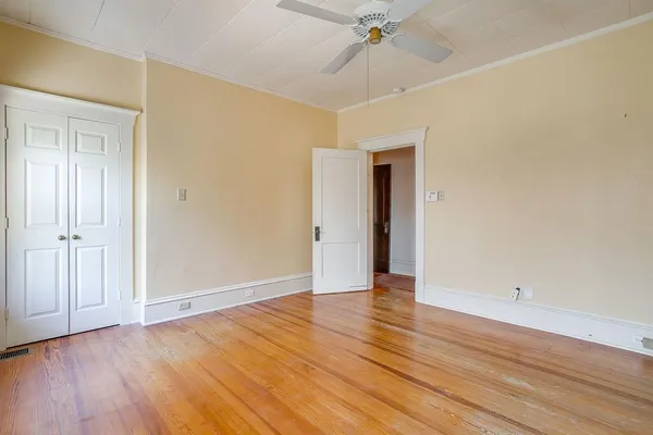 wooden floor in an empty room with a window