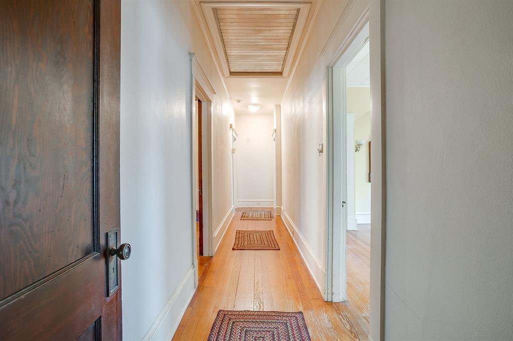 2124 Weatherbee Street Fort Worth, TX 76110 - Photo 29 of 39 a view of a hallway with wooden floor and staircase