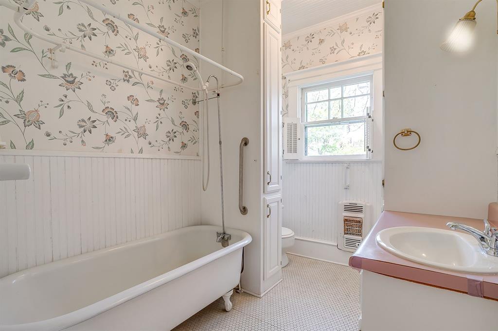 2124 Weatherbee Street Fort Worth, TX 76110 - Photo 30 of 39 a bathroom with a sink a bathtub and a window