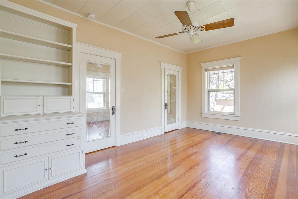 2124 Weatherbee Street Fort Worth, TX 76110 - Photo 32 of 39 a view of an empty room with a window and wooden floor