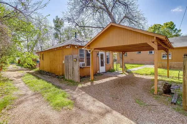 a room with a sink cabinets and a window