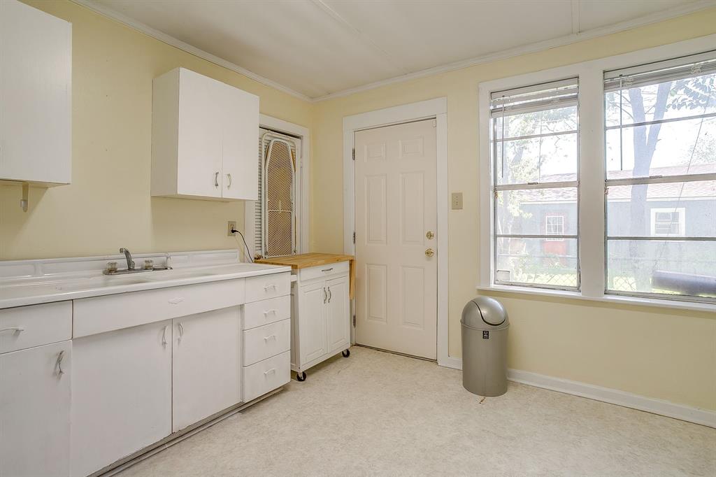 2124 Weatherbee Street Fort Worth, TX 76110 - Photo 37 of 39 a room with a sink cabinets and a window
