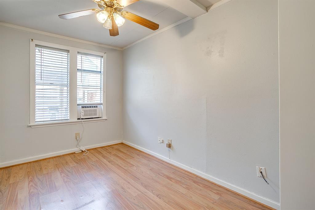 2124 Weatherbee Street Fort Worth, TX 76110 - Photo 38 of 39 wooden floor in an empty room with a window