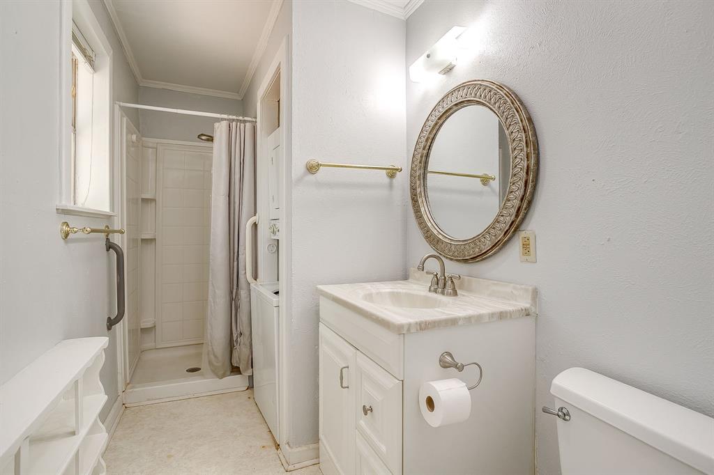 2124 Weatherbee Street Fort Worth, TX 76110 - Photo 39 of 39 a bathroom with a sink a toilet and a mirror