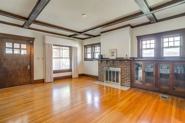 a view of a livingroom with wooden floor and windows