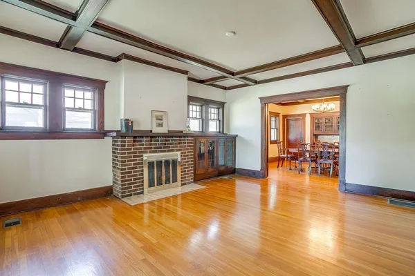 a view of a livingroom with furniture wooden floor and windows