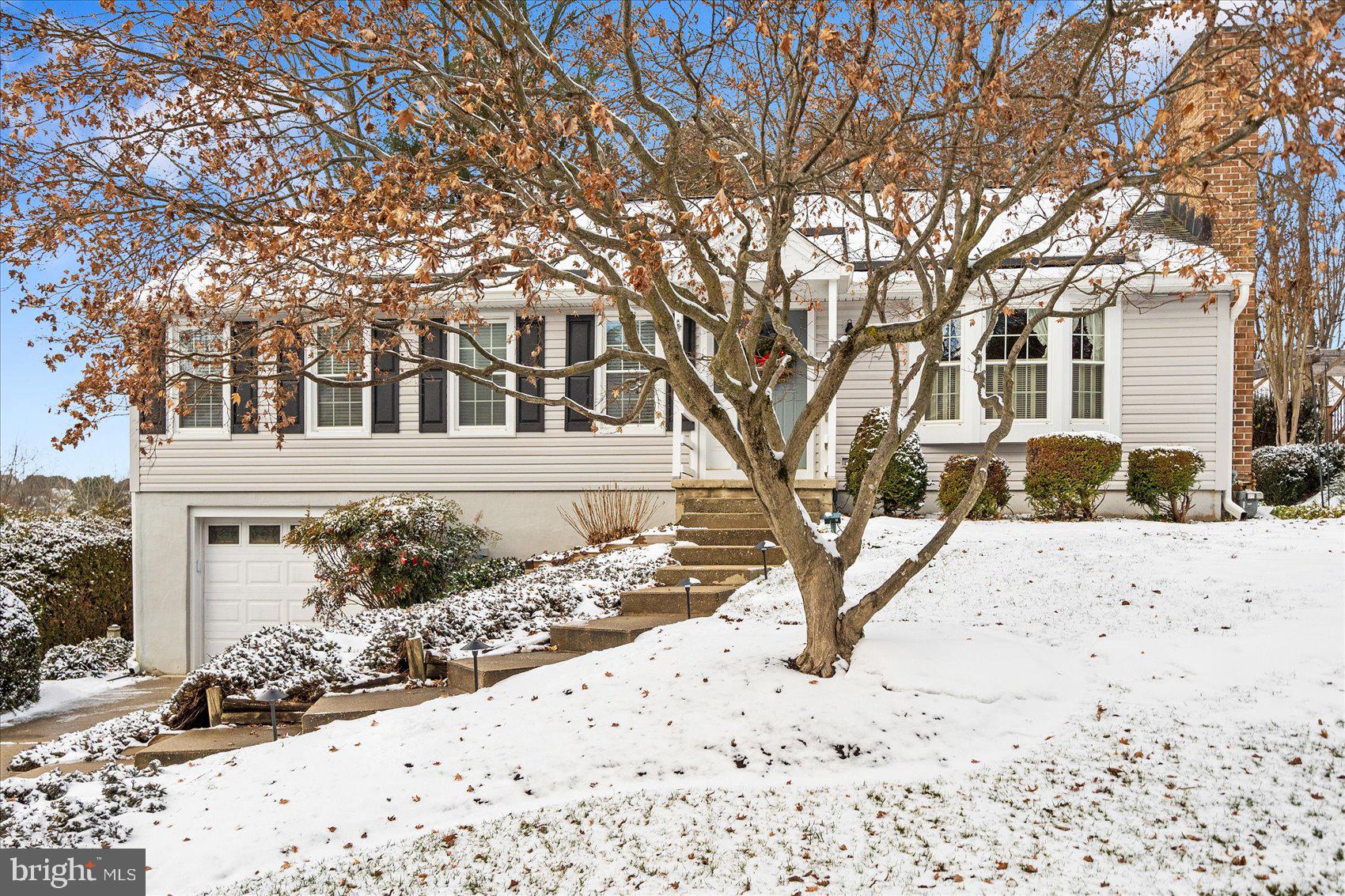 9414 Perglen Road Baltimore, MD 21236 - Photo 3 of 39 front view of a house with a yard covered in snow
