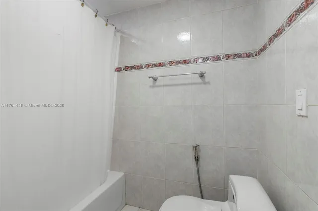 a bathroom with a shower and a toilet