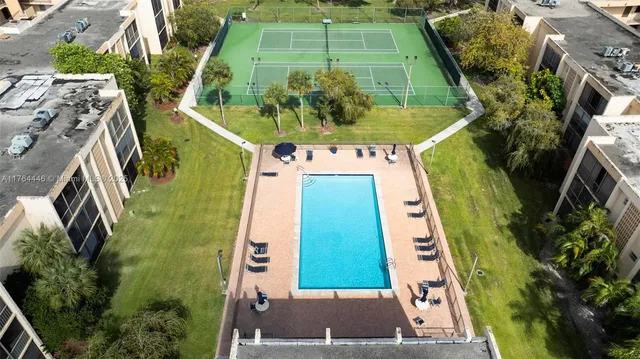 an aerial view of a residential houses with outdoor space