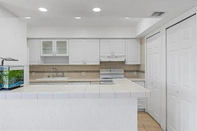 a view of washer and dryer with kitchen countertops