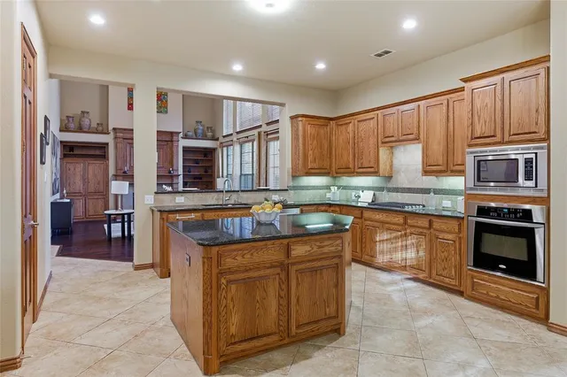 a kitchen with stainless steel appliances granite countertop a stove and a sink