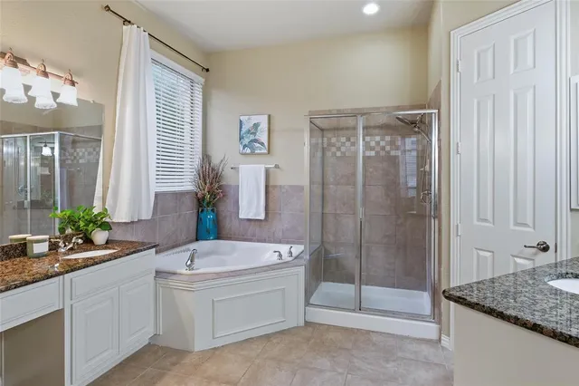 a bathroom with a tub sink and mirror