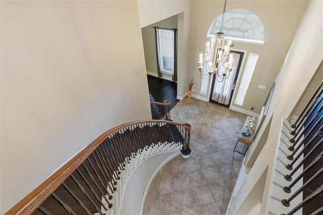 a view of a livingroom with wooden floor and staircase
