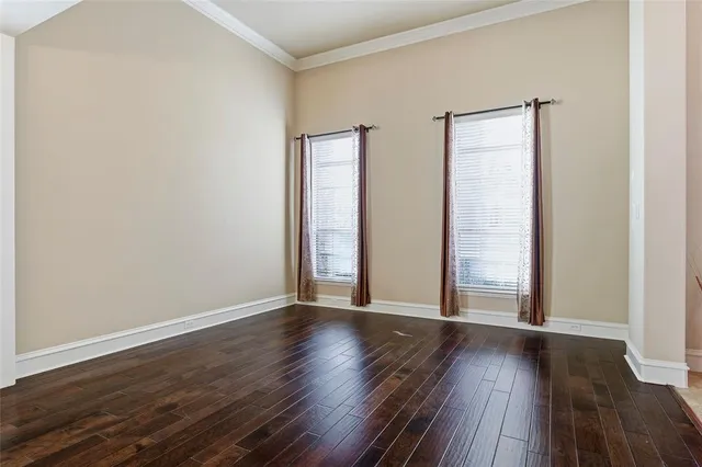 an empty room with wooden floor and closet