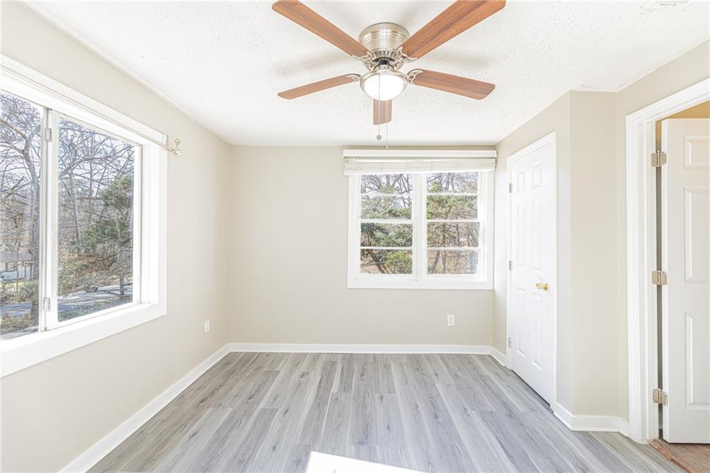 6197 Union Grove Road Lithia Springs, GA 30122 - Photo 12 of 24 a view of an empty room with wooden floor and a window