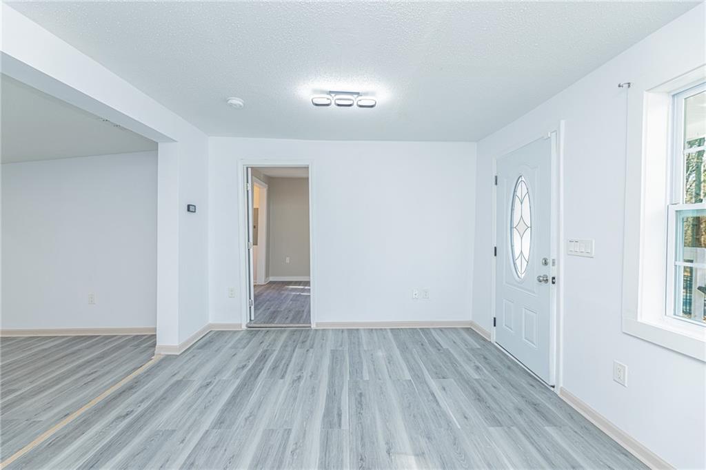 6197 Union Grove Road Lithia Springs, GA 30122 - Photo 15 of 24 wooden floor in an empty room with a window