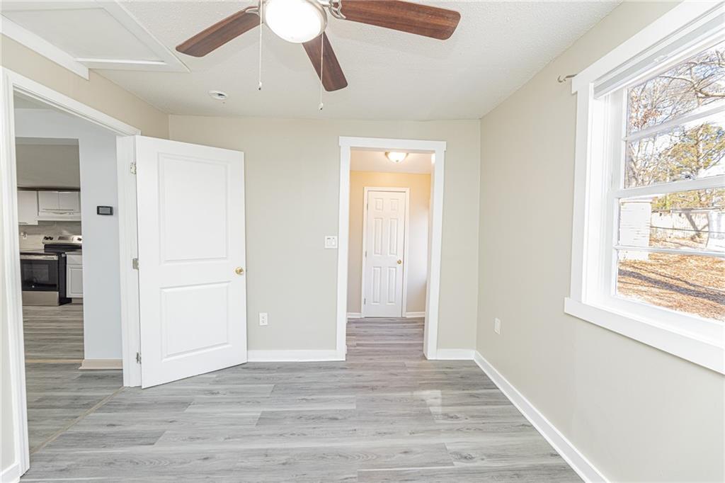 6197 Union Grove Road Lithia Springs, GA 30122 - Photo 16 of 24 a view of an empty room with wooden floor and a window