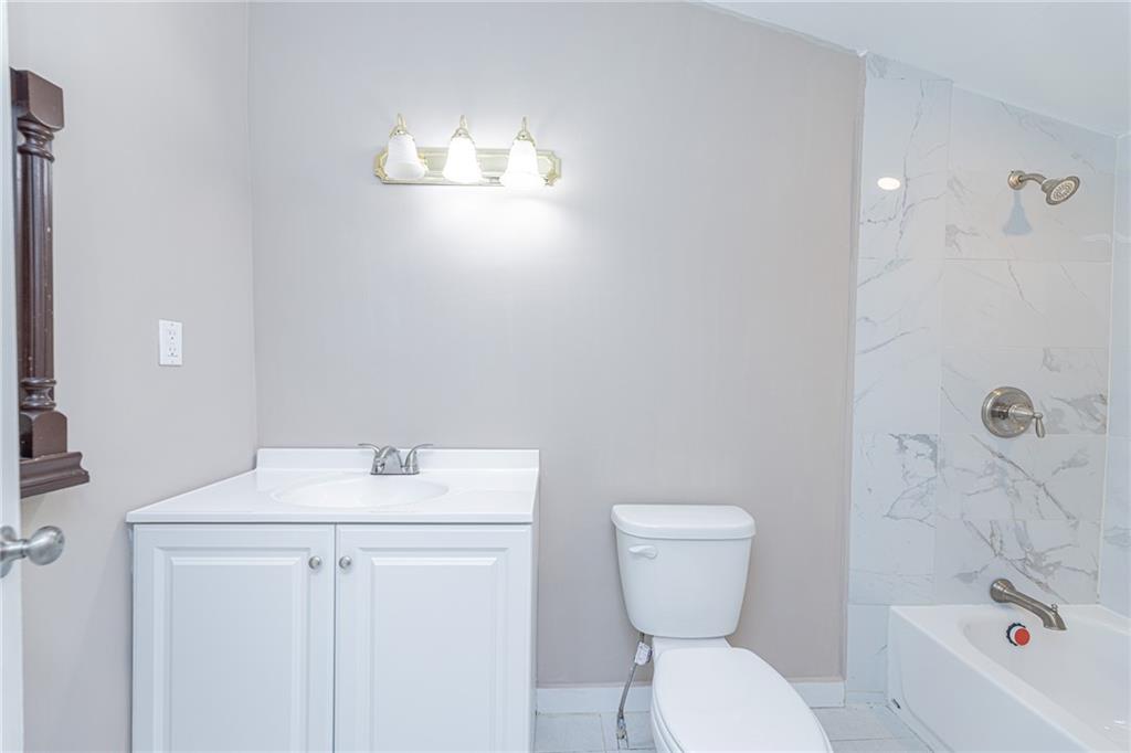 6197 Union Grove Road Lithia Springs, GA 30122 - Photo 17 of 24 a bathroom with a toilet sink and mirror