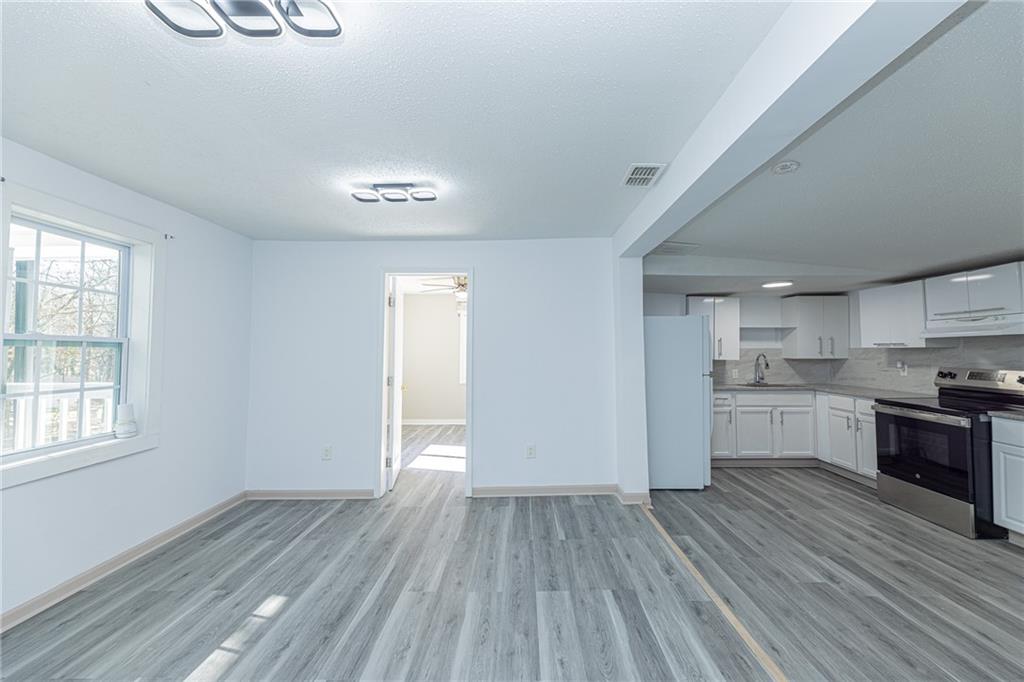 6197 Union Grove Road Lithia Springs, GA 30122 - Photo 19 of 24 a view of a kitchen center island wooden floor and stainless steel appliances