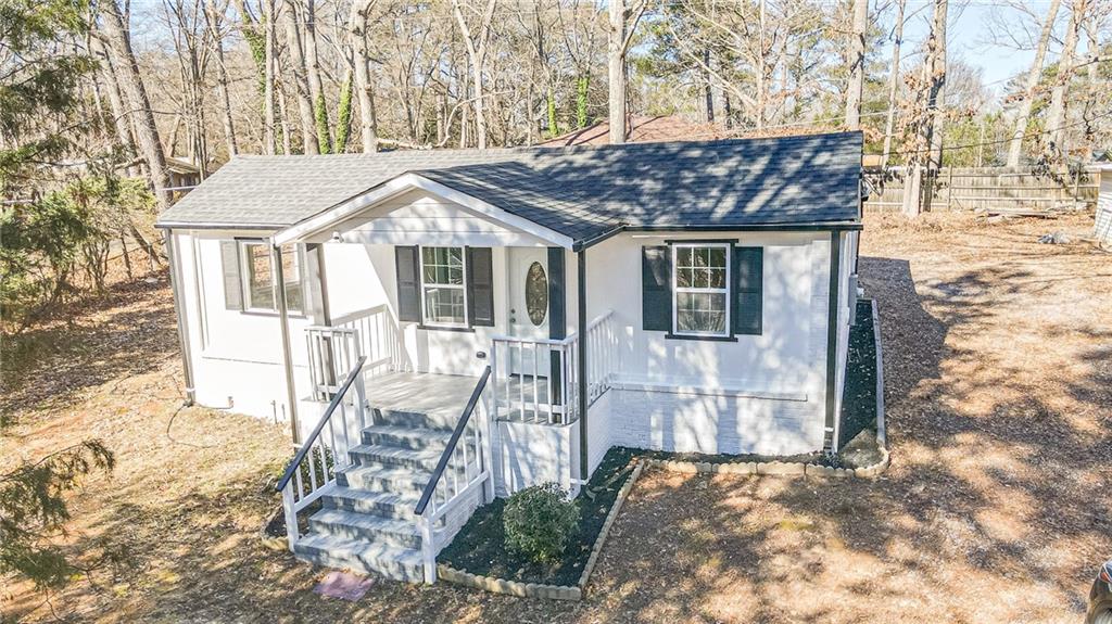 6197 Union Grove Road Lithia Springs, GA 30122 - Photo 20 of 24 a white house with tree in front of it
