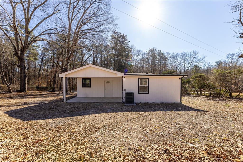 6197 Union Grove Road Lithia Springs, GA 30122 - Photo 21 of 24 a front view of a house with a yard