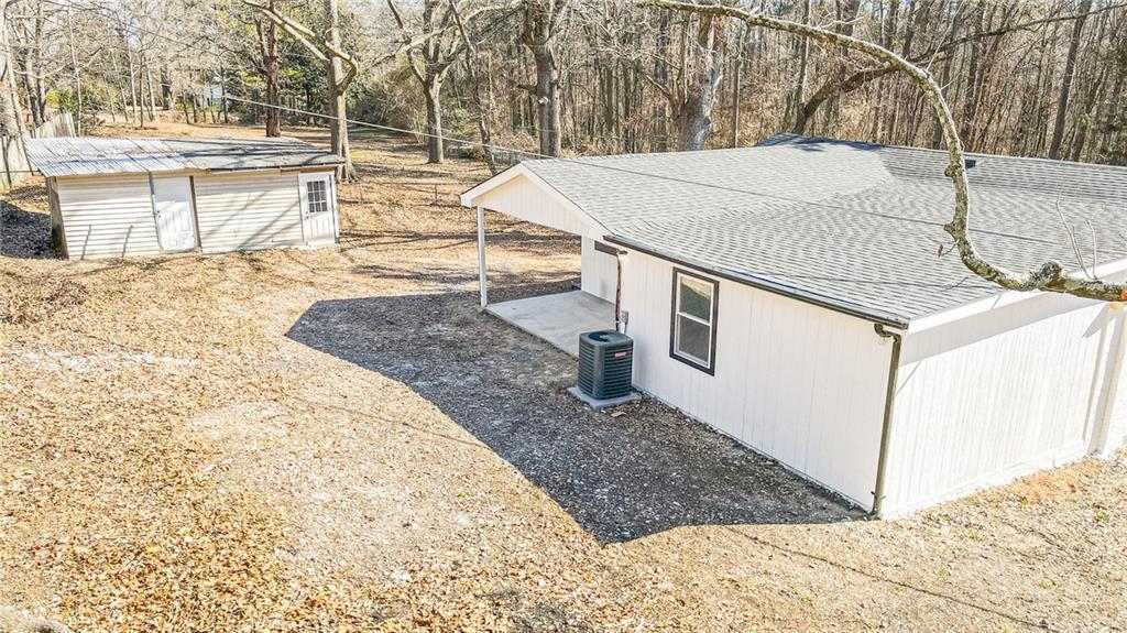 6197 Union Grove Road Lithia Springs, GA 30122 - Photo 22 of 24 a view of a backyard with snow on the road