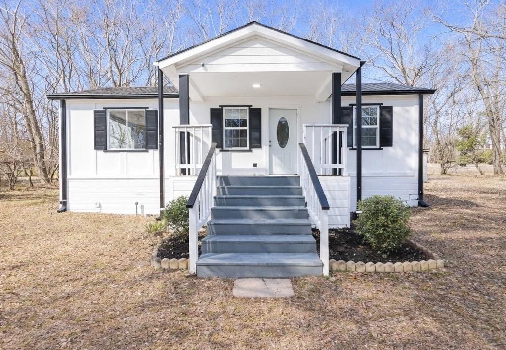 6197 Union Grove Road Lithia Springs, GA 30122 - Photo 24 of 24 a front view of a house with a yard