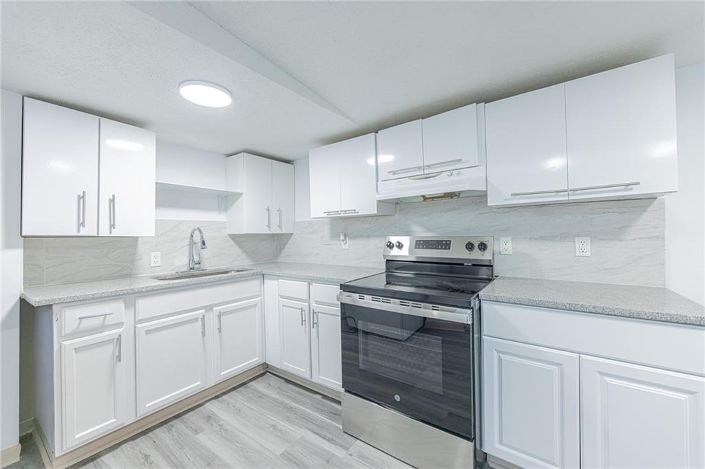 6197 Union Grove Road Lithia Springs, GA 30122 - Photo 4 of 24 a kitchen with cabinets stainless steel appliances and a sink