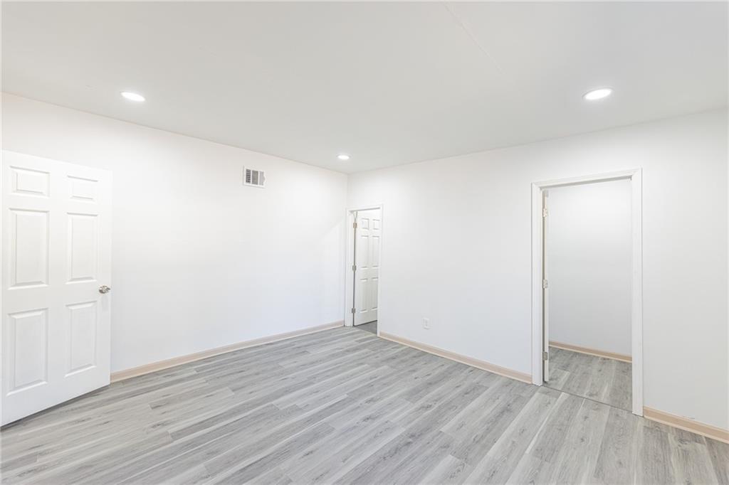 6197 Union Grove Road Lithia Springs, GA 30122 - Photo 6 of 24 a view of an empty room with wooden floor