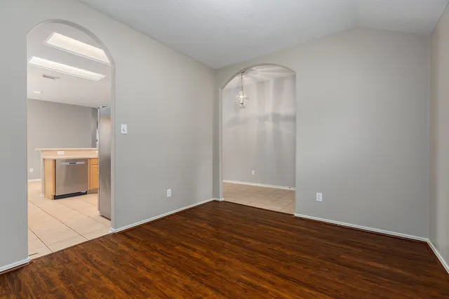 a kitchen with stainless steel appliances granite countertop a sink a stove a refrigerator with grey cabinets