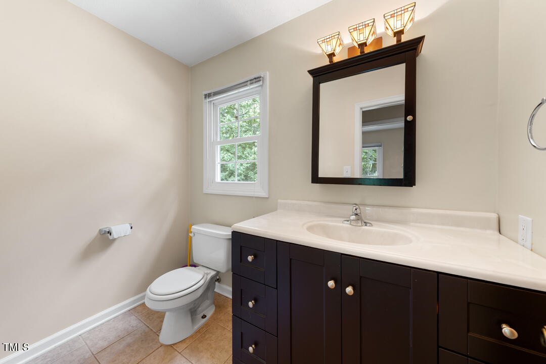 122 Stedwick Place Durham, NC 27712 - Photo 19 of 35 a bathroom with a toilet sink and mirror