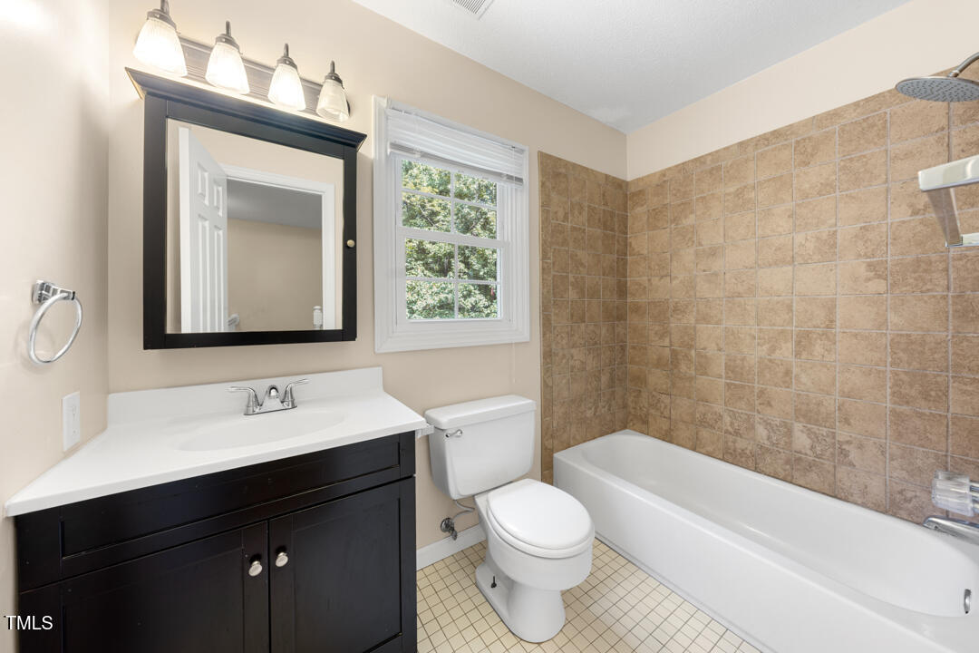 122 Stedwick Place Durham, NC 27712 - Photo 25 of 35 a bathroom with a toilet sink vanity tub and mirror