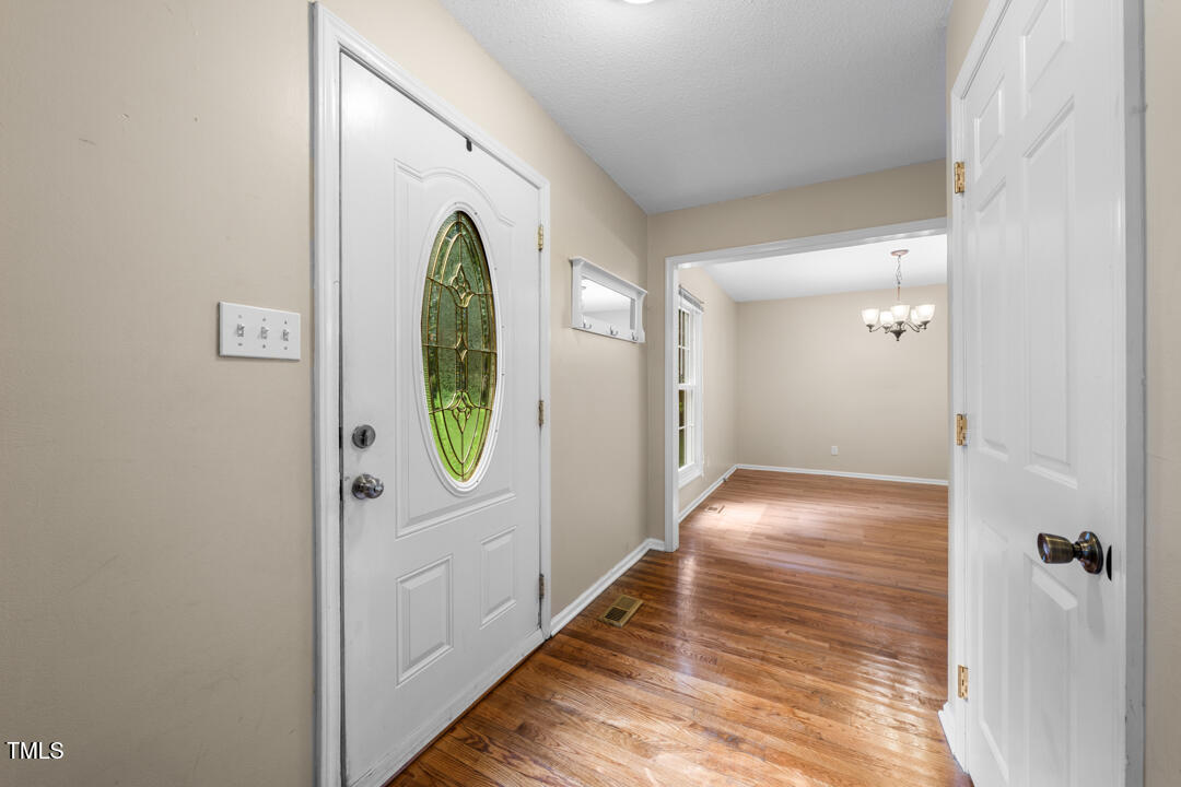 122 Stedwick Place Durham, NC 27712 - Photo 4 of 35 a view of a hallway with wooden floor and entryway